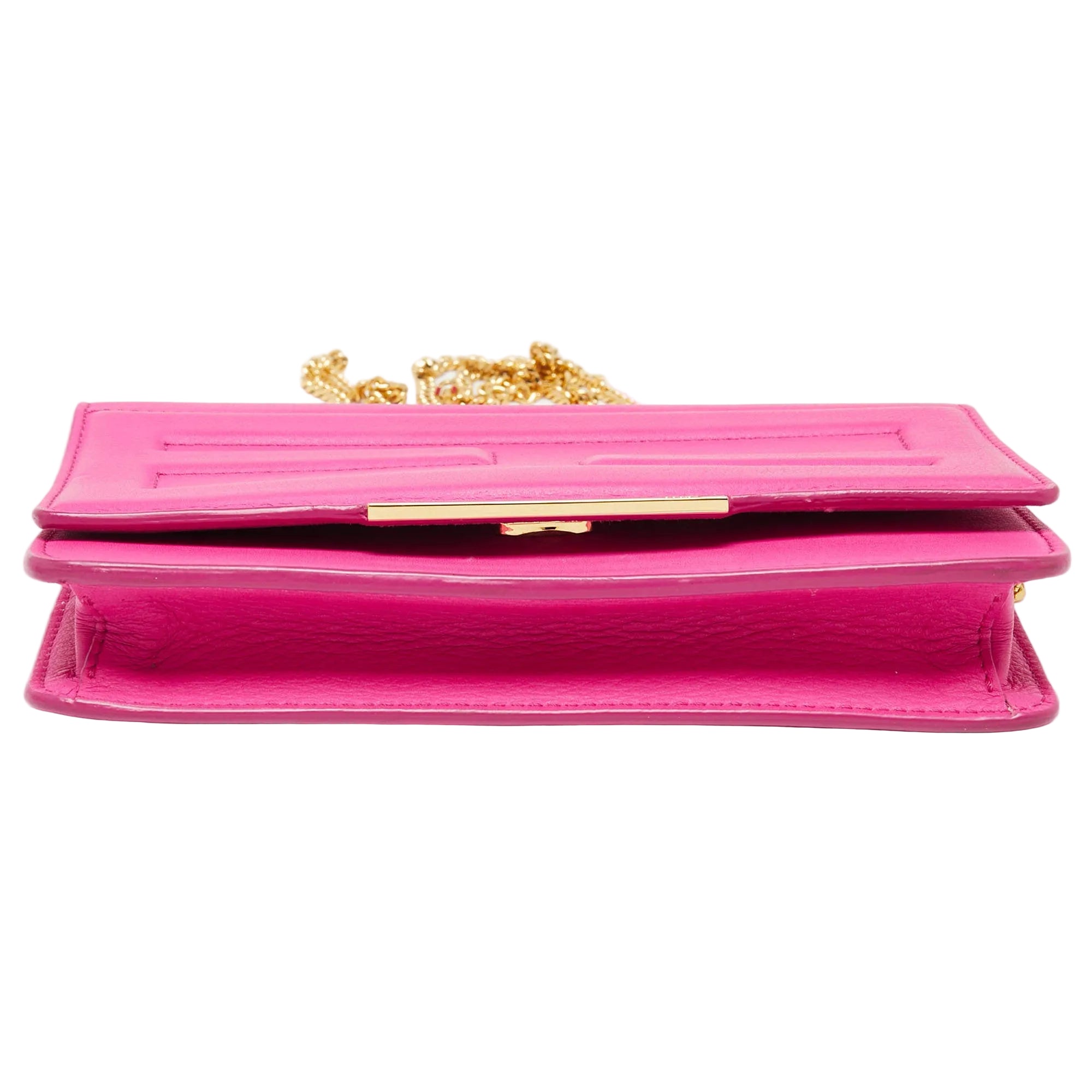 A bright pink leather clutch bag with a gold-tone chain strap and a gold-tone front clasp, shown against a plain white background.
