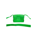 Bottega Veneta Candy Cassette mini bag in bright Parakeet Green maxi Intreccio woven leather, featuring an adjustable leather belt strap and silver-tone hardware.