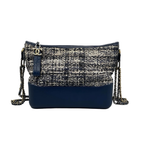 Front view of a Chanel Small Gabrielle Hobo bag featuring navy quilted tweed, a structured navy blue calfskin base, and a multi-metal chain strap in gold, silver, and ruthenium.