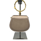 Front view of a Chloé Small Nile Bracelet bag in Motty Grey leather and suede, featuring the iconic gold-tone ring handle and a matching leather crossbody strap on a white background.
