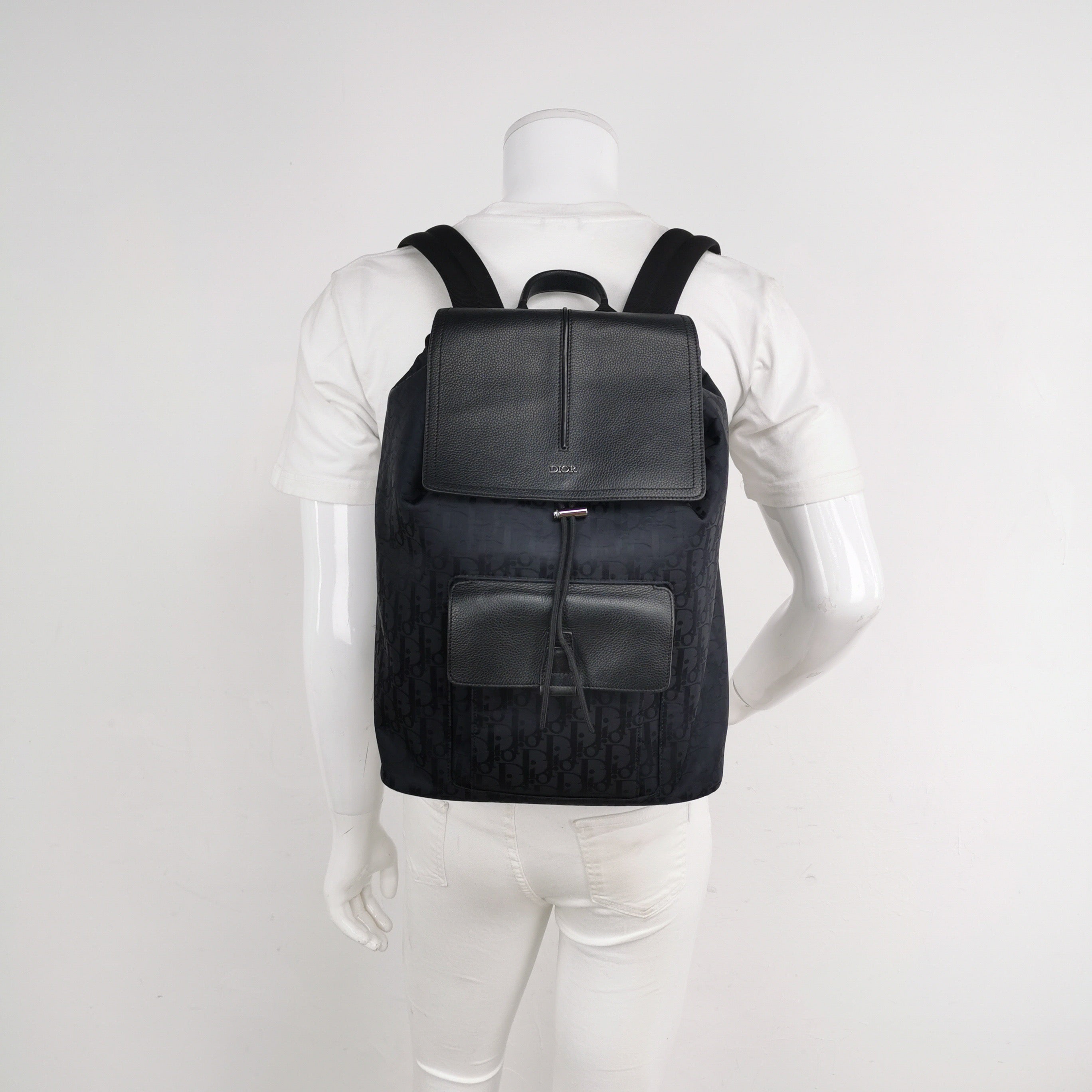 Black christian dior oblique canvas and leather backpack on a mannequin for size reference in excellent condition 