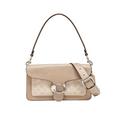 A Coach shoulder bag in beige and taupe leather with the brand's signature monogram pattern, a silver-tone 'C' logo clasp, and a matching adjustable shoulder strap, shown against a light gray background.