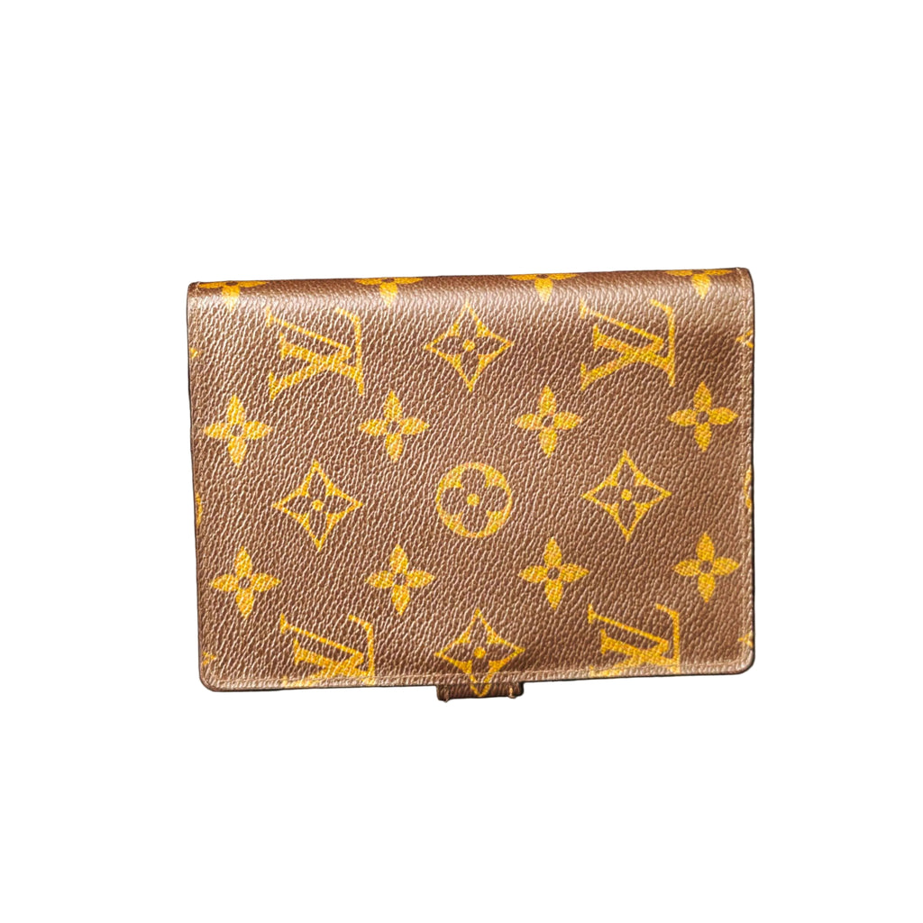 Louis Vuitton wallet with monogram pattern on a dark background