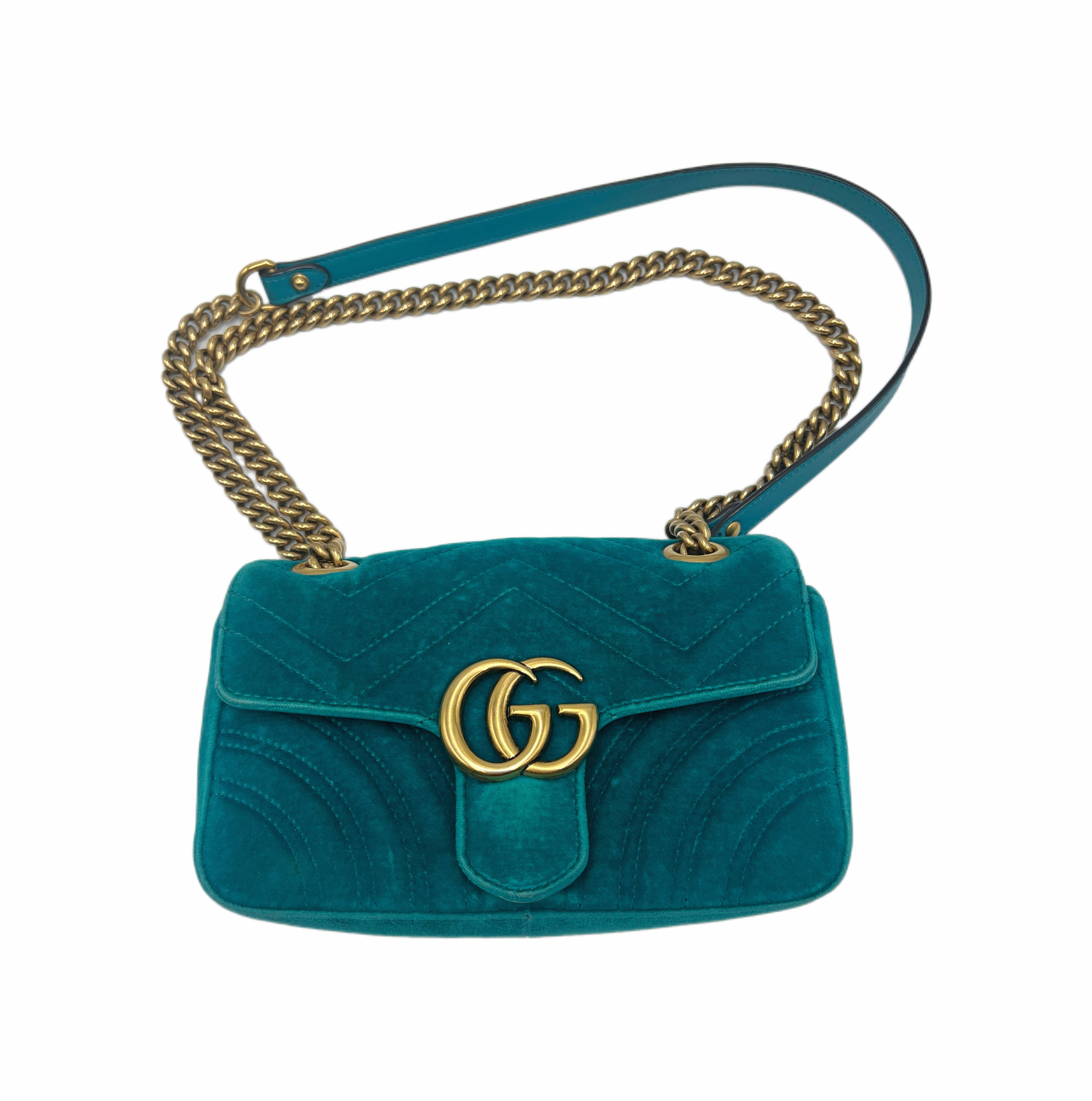 Teal handbag with gold chain strap and logo on a white background