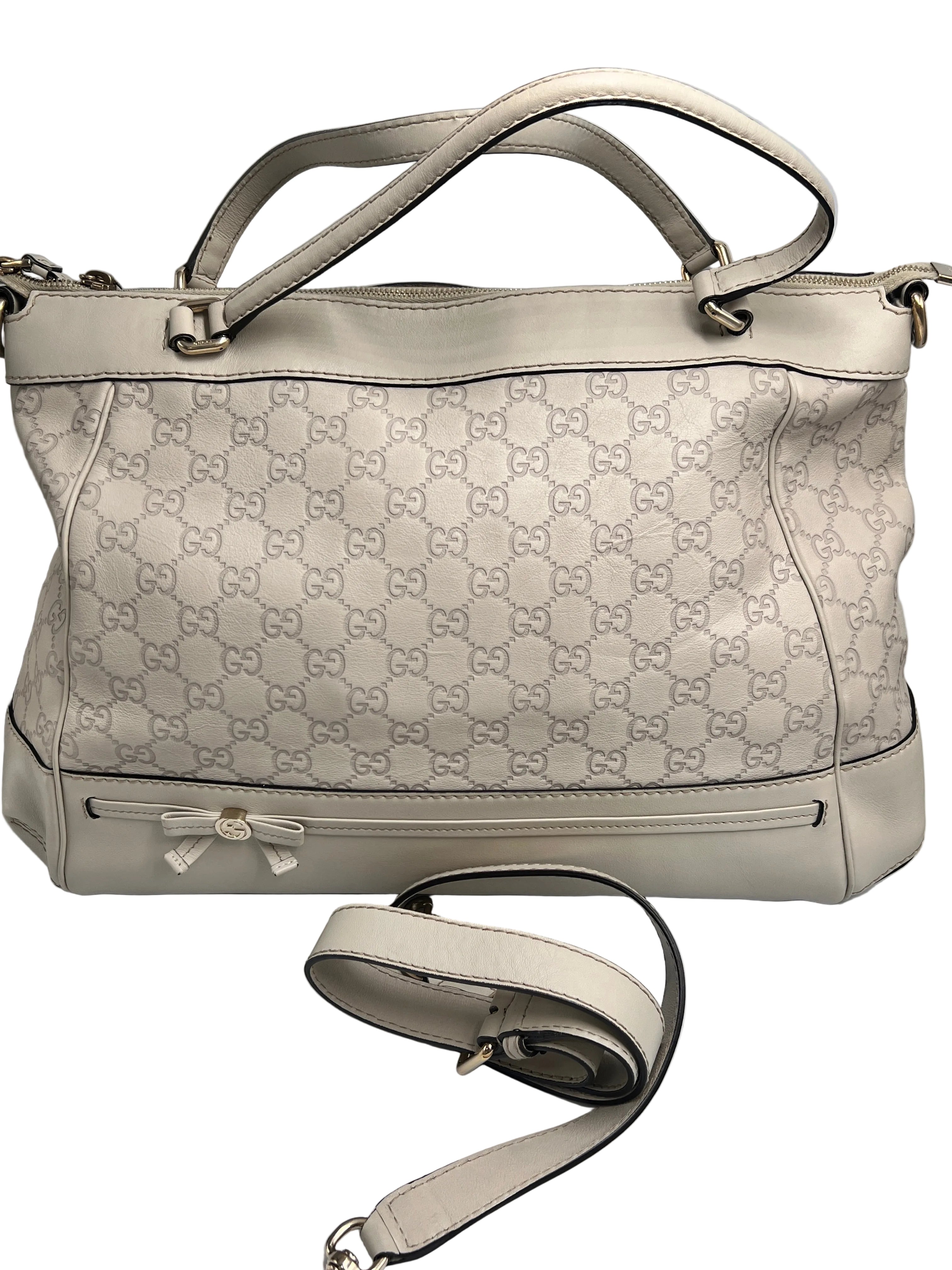 Authentic pre-owned Gucci white Micro Guccissima debossed leather tote bag featuring a bow accent, top handles, and original shoulder strap.