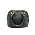 Black textured handbag with gold accents on a white background