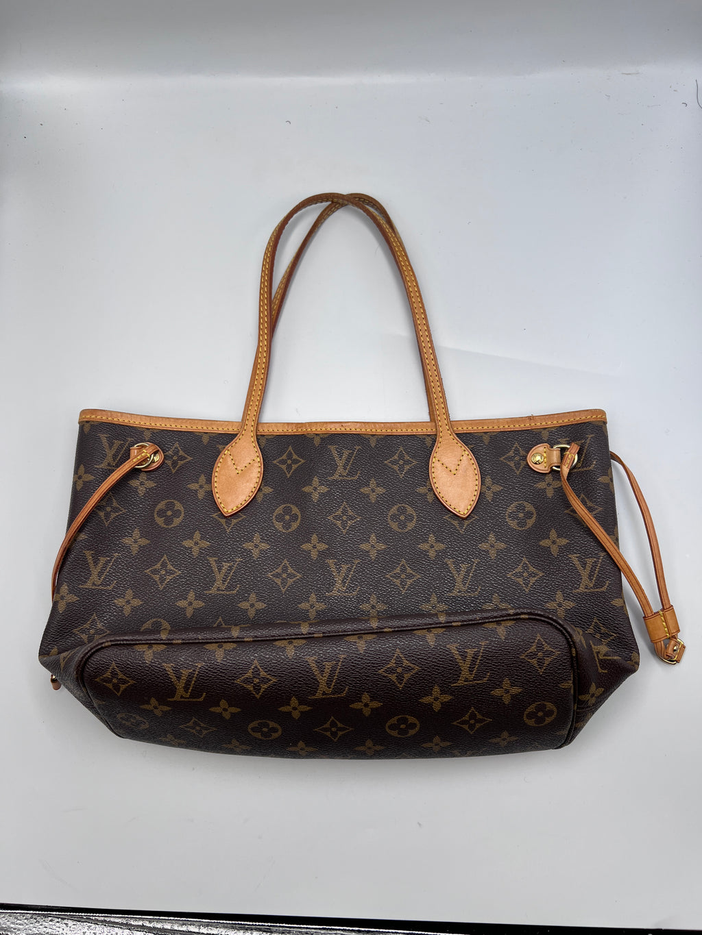 Louis Vuitton Monogram Neverfull PM tote bag with Vachetta leather handles and side laces
