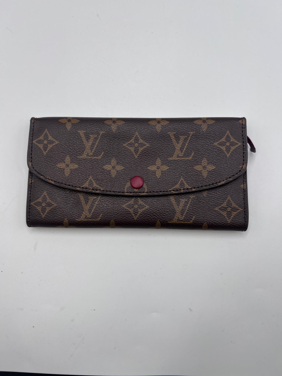 Authentic pre-owned Louis Vuitton Monogram Sarah long wallet in brown coated canvas featuring a distinctive red snap button closure.
