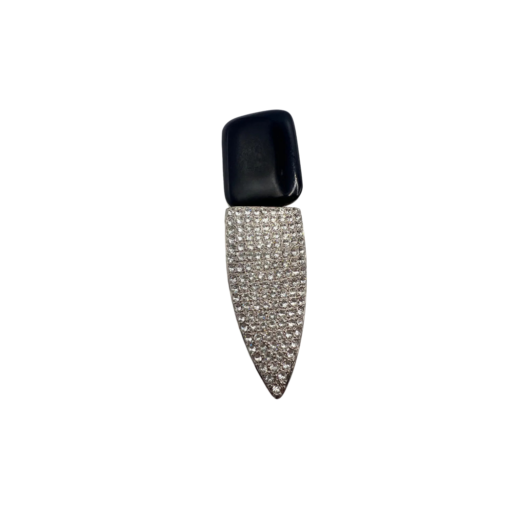 Decorative nail tip with black cap and rhinestone design on a white background