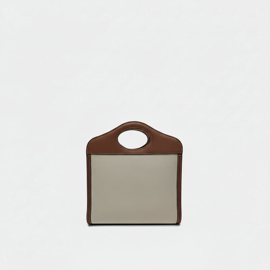 the back view of preowned burberry mini canvas pocket tophandle bag in excellent condition in brown leather and beige canvas