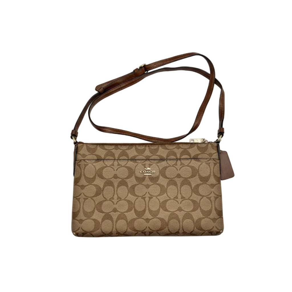 Front view of Coach East West Pop Up Messenger in brown Signature canvas with Saddle leather trim and adjustable strap.