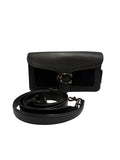A black leather shoulder bag with a textured flap and a large silver-tone buckle, shown with its matching black leather strap coiled in front on a light gray background.