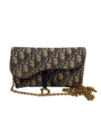 Front view of a Christian Dior Saddle Pouch in blue Dior Oblique jacquard canvas with antique gold D charm and chain.
