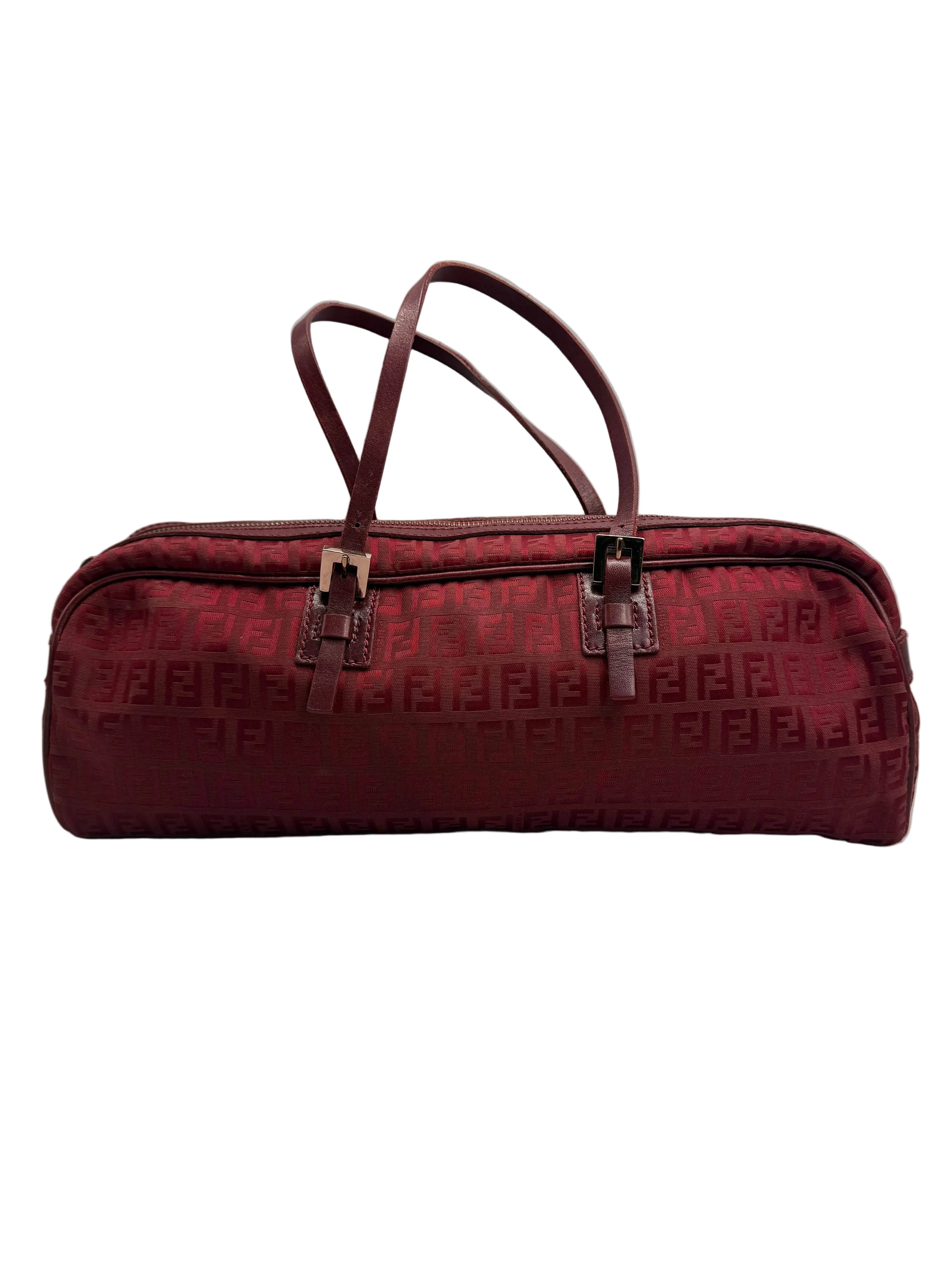Front view of a vintage Fendi elongated cylindrical barrel shoulder bag in burgundy Zucca monogram canvas with thin leather straps.