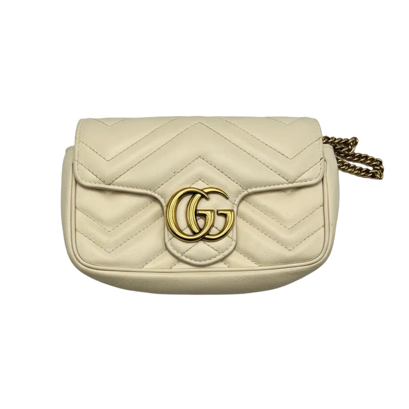 Front view of a Gucci GG Marmont Super Mini bag in beige chevron quilted leather with gold-tone GG logo.