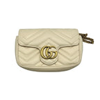 Front view of a Gucci GG Marmont Super Mini bag in beige chevron quilted leather with gold-tone GG logo.