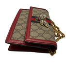 Designer handbag with bee emblem and chain strap