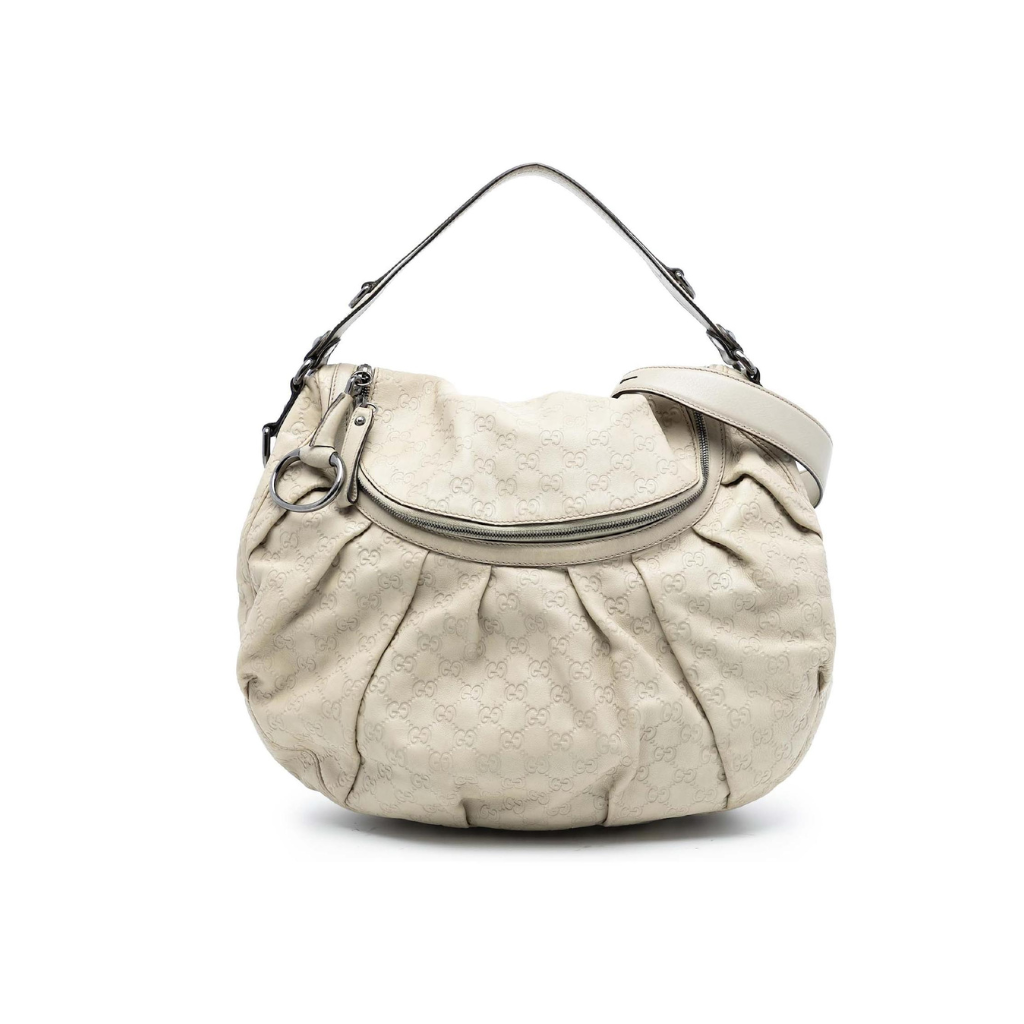 Front view of a Gucci Pelham hobo bag in off-white embossed Guccissima leather with gunmetal hardware.