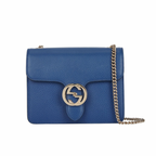 Front view of a black Gucci Interlocking G shoulder bag with gold-tone hardware and chain strap.