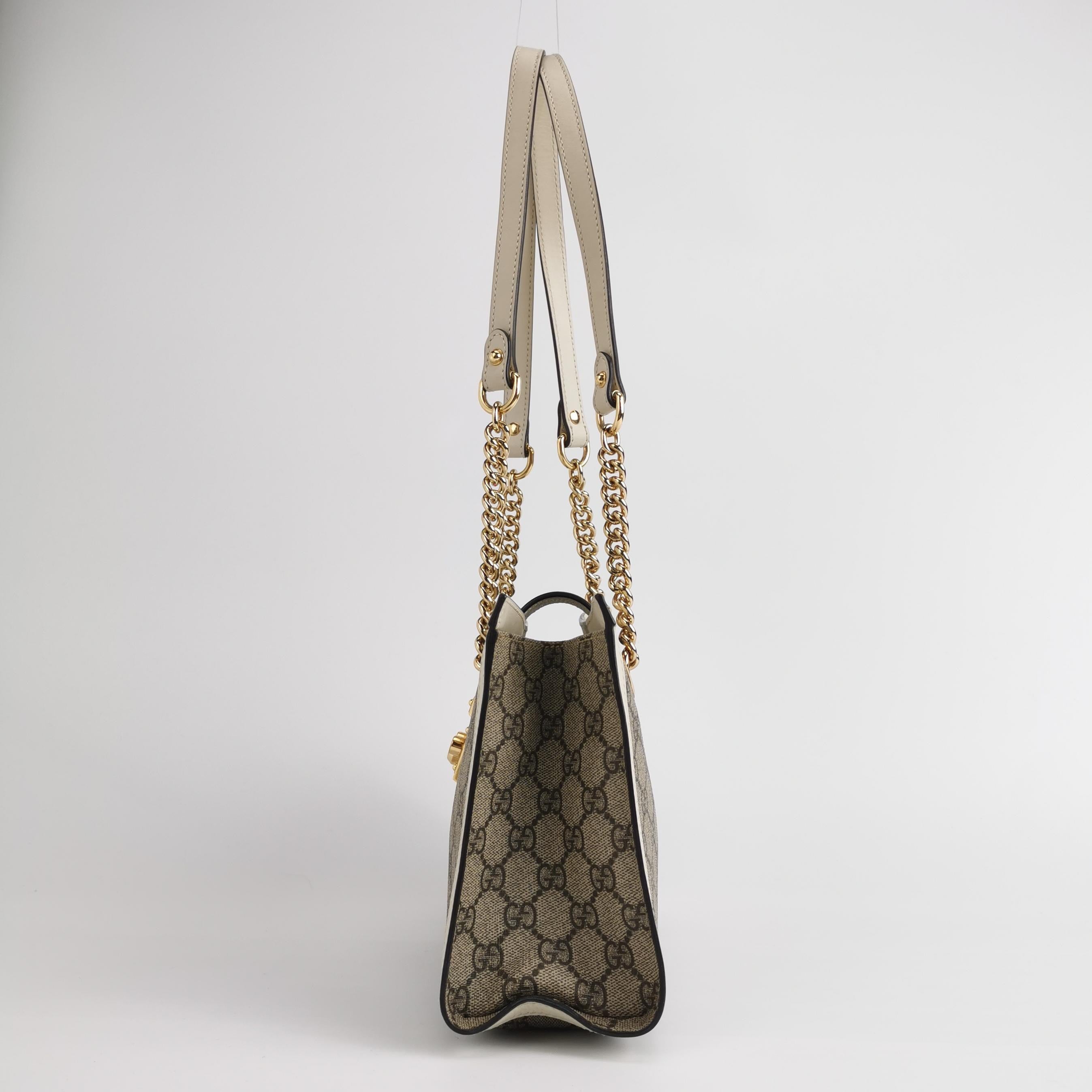 side of gucci padlock tote bag in gg canvas and white leather with shoulder strap 