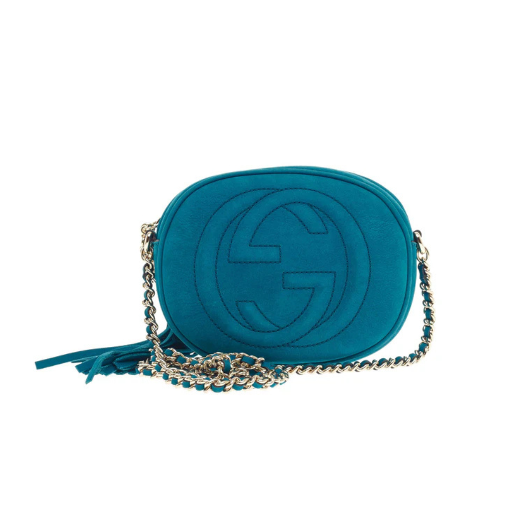 Front view of a red Gucci Soho Disco bag with embossed GG logo and leather tassel zipper pull.