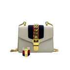 preowned authentic gucci svlvia in white leather crossbody in red and green strap with gold hardware in very good condition 