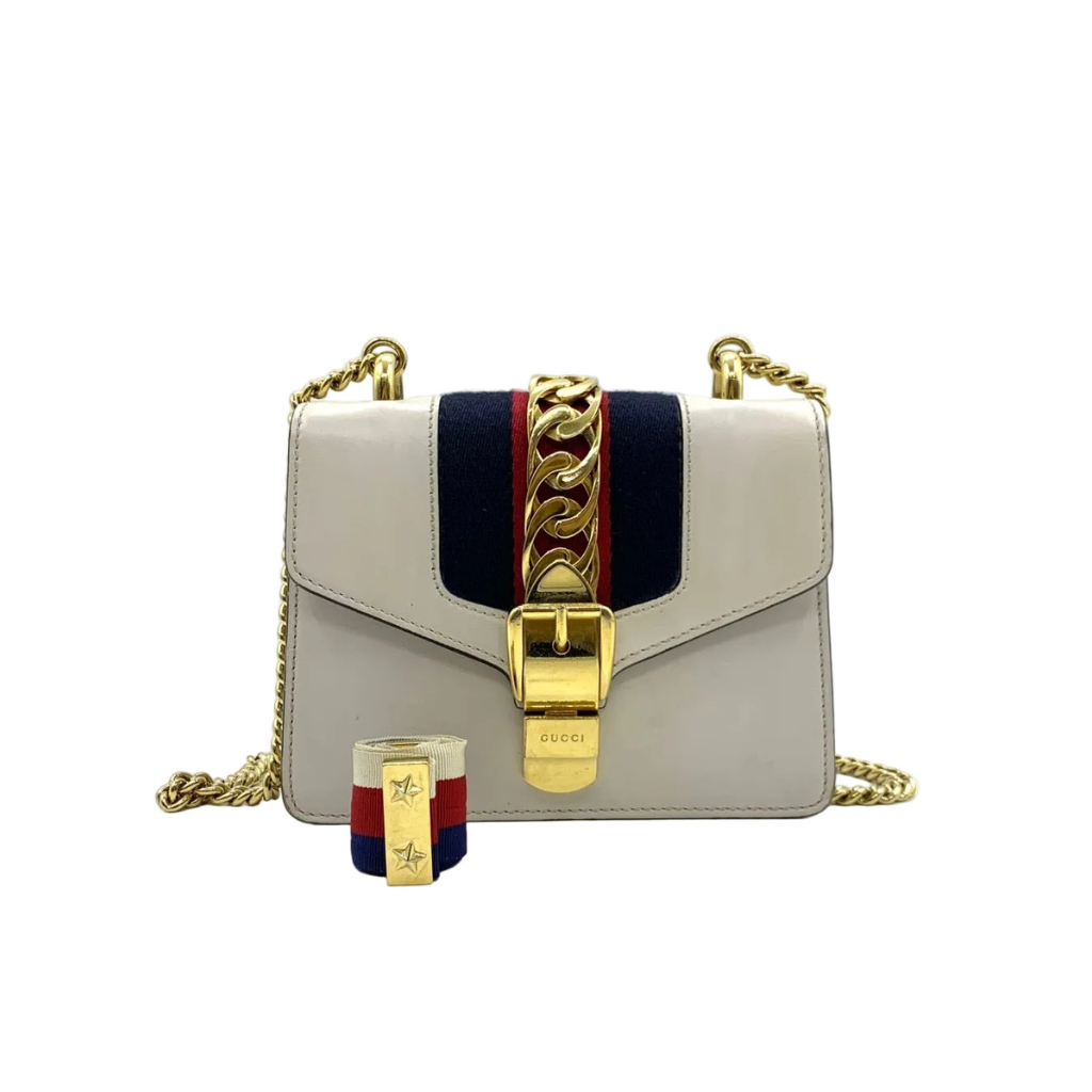 preowned authentic gucci svlvia in white leather crossbody in red and green strap with gold hardware in very good condition 