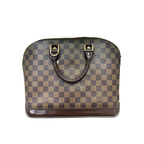 Front view of a Louis Vuitton Alma PM handbag in Damier Ébène canvas with dark brown leather trim and gold hardware.