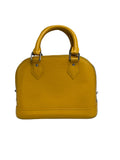 A small structured handbag in bright yellow textured leather with a top handle, silver-tone hardware, and a zip-around closure, photographed against a plain light gray studio background.