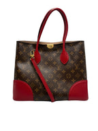 Front view of a Louis Vuitton Flandrin bag in Monogram canvas with red leather handles and corner accents.