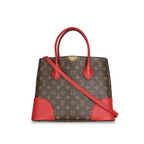 Front view of a Louis Vuitton Flandrin bag in Monogram canvas with red leather handles and corner accents.