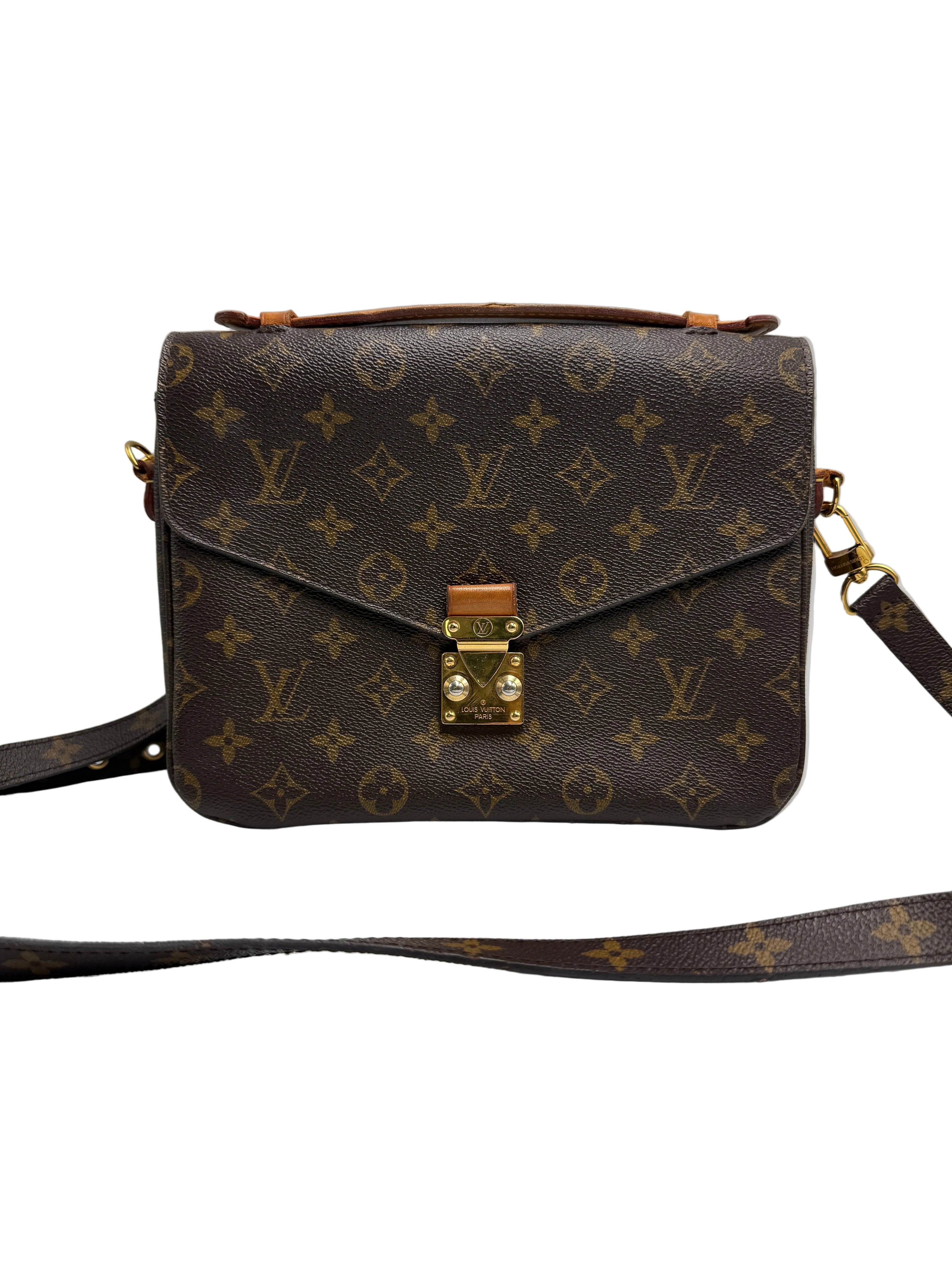 A Louis Vuitton monogram canvas shoulder bag in dark brown with gold-tone hardware and a top handle, shown against a neutral gray background.