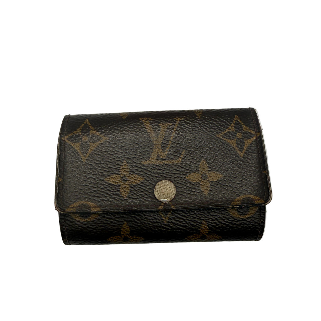 Louis Vuitton 6-key holder in brown Monogram canvas with a fuchsia pink leather interior and gold-tone hardware.