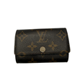 Louis Vuitton 6-key holder in brown Monogram canvas with a fuchsia pink leather interior and gold-tone hardware.