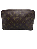 Front view of a vintage Louis Vuitton Trousse Toilette 28 cosmetic pouch in Monogram canvas.