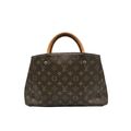 Front view of Louis Vuitton Montaigne BB bag in Monogram canvas with tan Vachetta leather handles and gold-tone hardware.