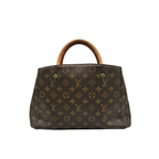 Front view of Louis Vuitton Montaigne BB bag in Monogram canvas with tan Vachetta leather handles and gold-tone hardware.