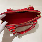 the interior of authentic louis vuitton alma bb nag in red patent leather the inside is clean and no mark or stain