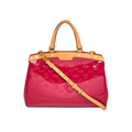 Louis Vuitton Brea handbag in glossy magenta patent leather with tan monogram embossing, tan leather handles and shoulder strap, and gold-tone hardware, shown on a white background.