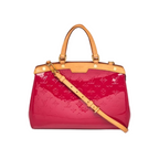 Louis Vuitton Brea handbag in glossy magenta patent leather with tan monogram embossing, tan leather handles and shoulder strap, and gold-tone hardware, shown on a white background.