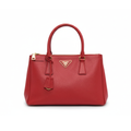 Front view of a red Prada Saffiano Lux Galleria tote bag featuring gold-tone hardware and double top handles.