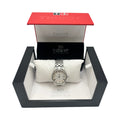 A Tissot stainless steel ladies watch with a white Roman numeral dial, displayed on a white pillow inside its original red and black Tissot presentation box.