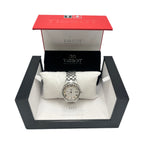 A Tissot stainless steel ladies watch with a white Roman numeral dial, displayed on a white pillow inside its original red and black Tissot presentation box.