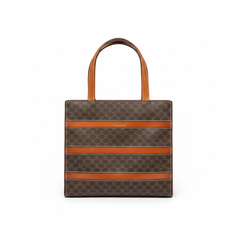 Front view of a vintage Celine horizontal tote bag in brown Macadam monogram canvas with tan leather straps.