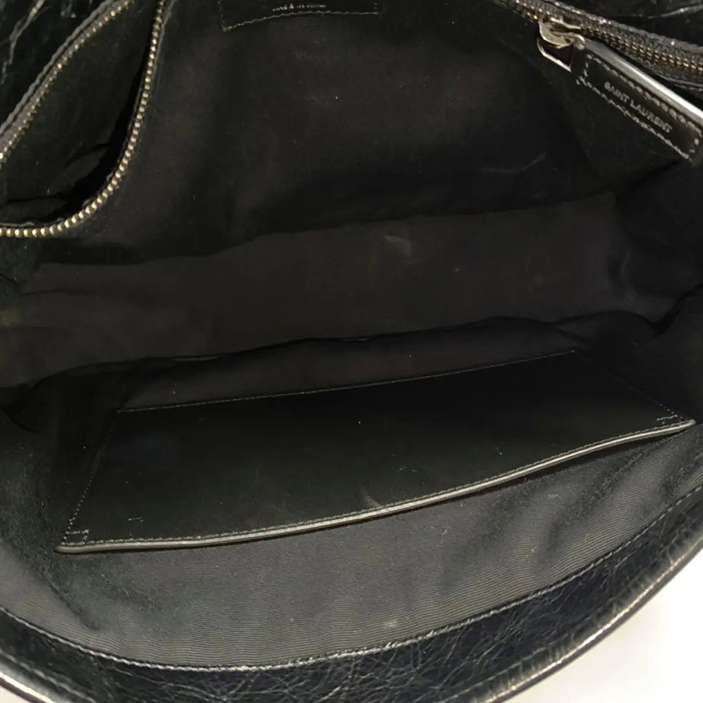 inside of ysl niki medium bag in black and soft leather the inside is clean and no marks or stain
