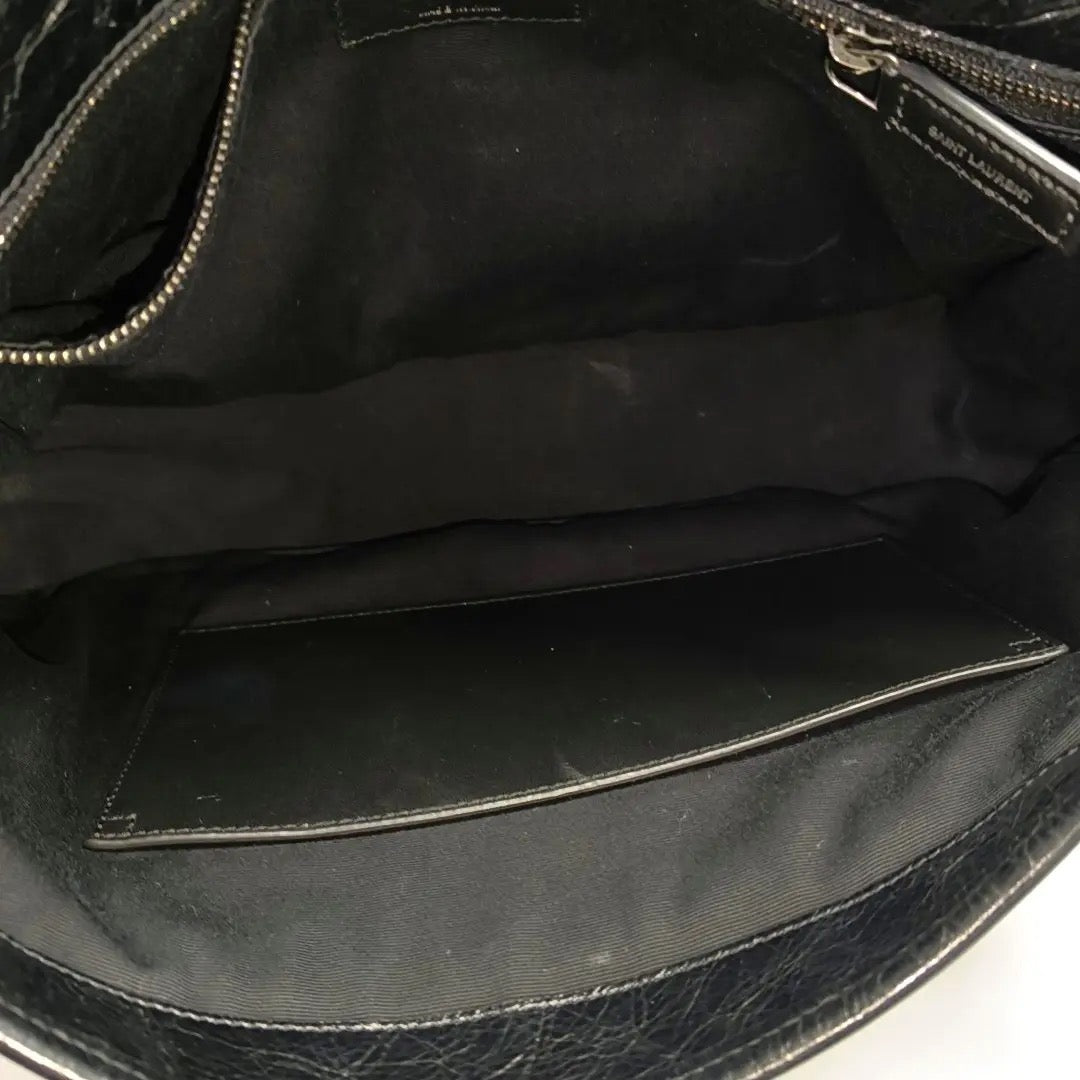 inside of ysl niki medium bag in black and soft leather the inside is clean and no marks or stain